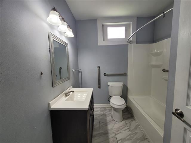 bathroom with toilet, vanity, and walk in shower