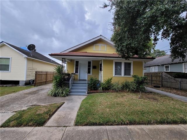 bungalow-style house with a porch and a front yard