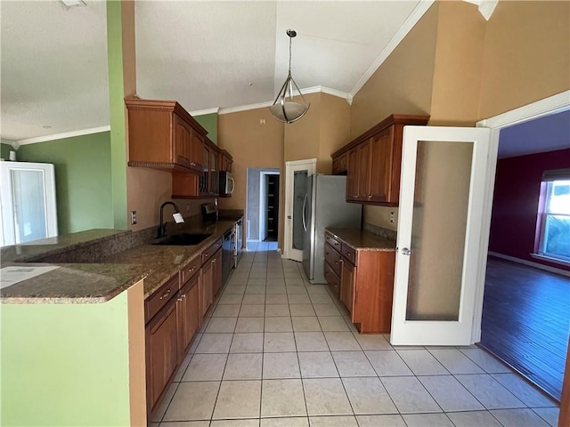 kitchen featuring light hardwood / wood-style floors, sink, appliances with stainless steel finishes, ornamental molding, and pendant lighting