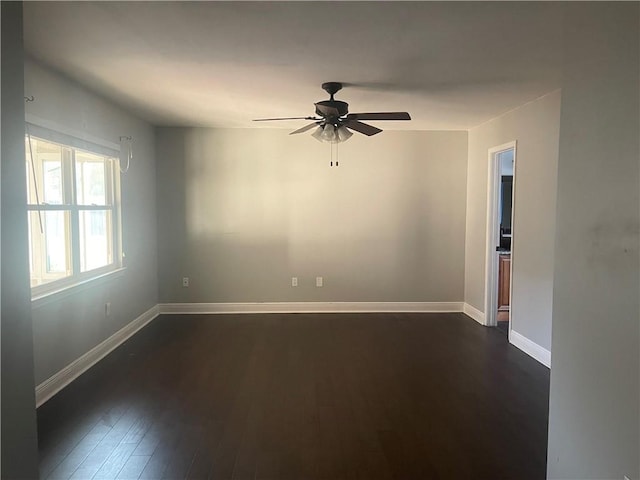 spare room with ceiling fan and dark hardwood / wood-style floors