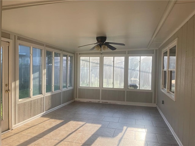 unfurnished sunroom with a wealth of natural light and ceiling fan