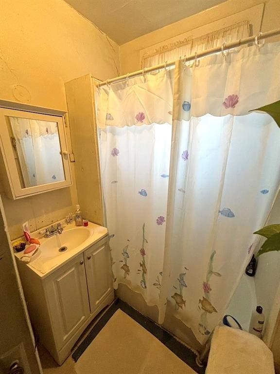 bathroom featuring vanity and a shower with shower curtain