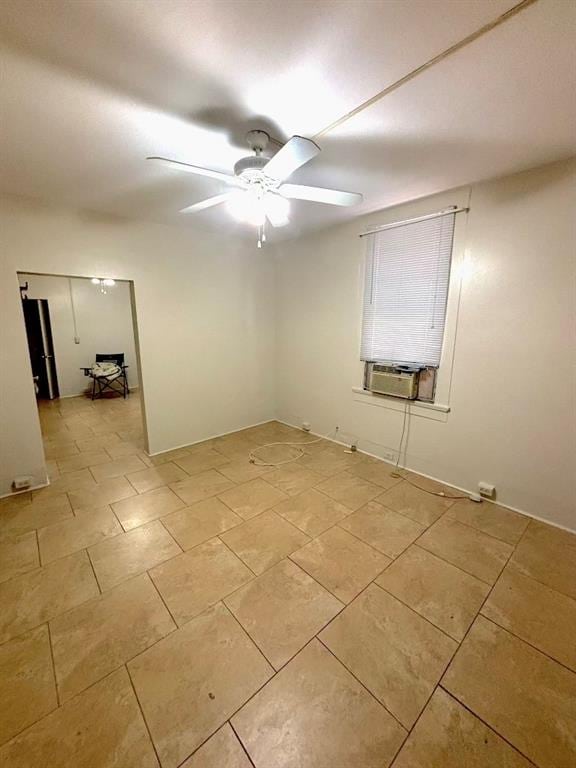 empty room with cooling unit and ceiling fan