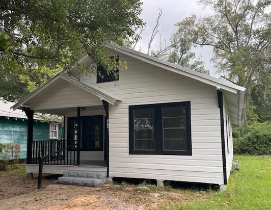 back of property featuring a porch