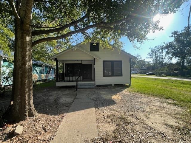 back of property with a porch