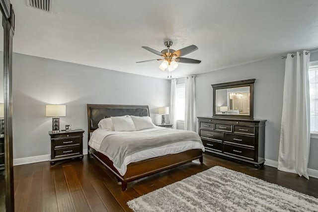 bedroom with ceiling fan and dark hardwood / wood-style flooring