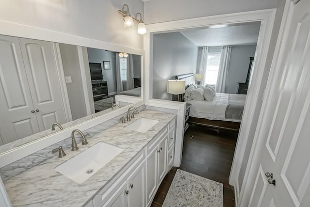 bathroom with hardwood / wood-style floors, vanity, and a wood stove