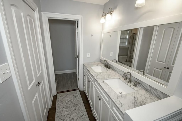 bathroom featuring vanity, toilet, and hardwood / wood-style flooring