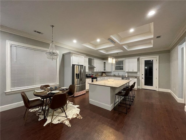 kitchen with stainless steel appliances, decorative light fixtures, dark hardwood / wood-style floors, coffered ceiling, and a center island