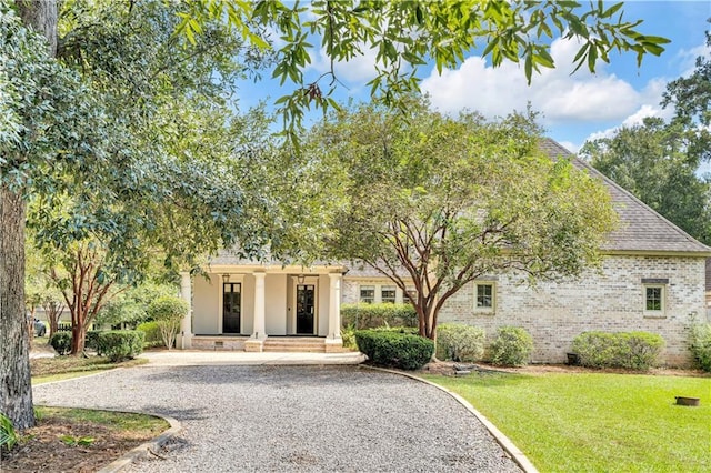 view of front facade with a front yard and covered porch