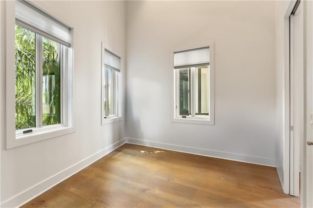 unfurnished room featuring light hardwood / wood-style flooring and a healthy amount of sunlight