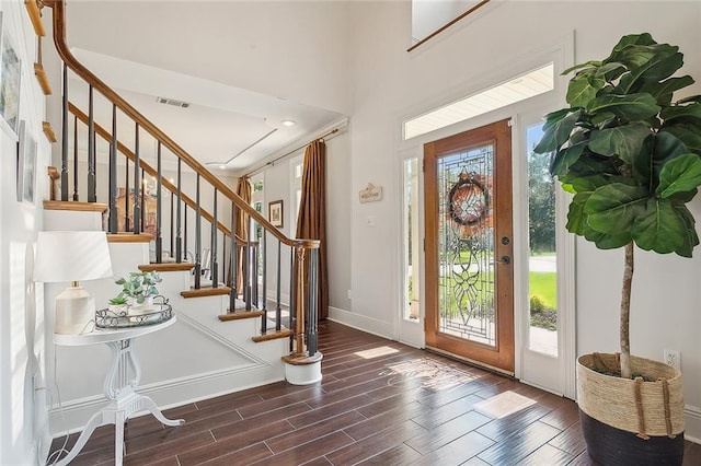 entryway with dark hardwood / wood-style flooring