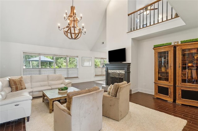 living room featuring a notable chandelier, high vaulted ceiling, and dark hardwood / wood-style floors