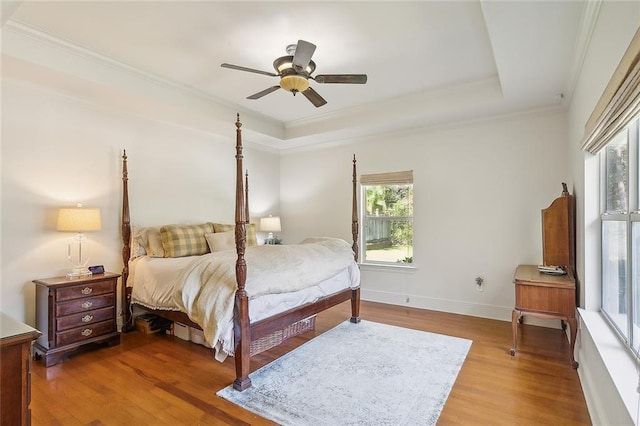 bedroom featuring wood-type flooring, crown molding, and ceiling fan