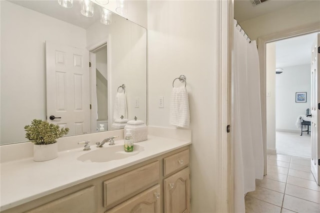 bathroom featuring tile patterned flooring and vanity