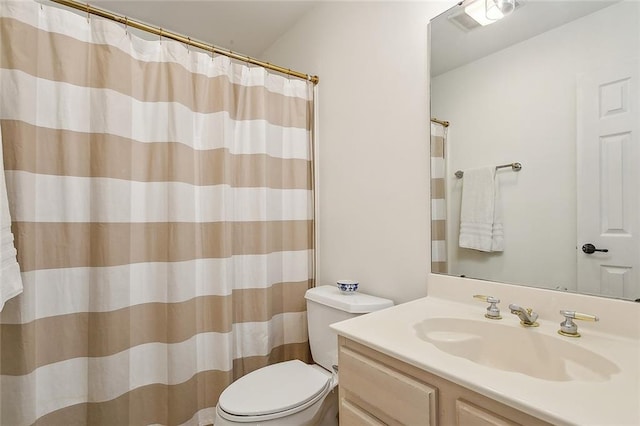 bathroom with vanity, toilet, and curtained shower