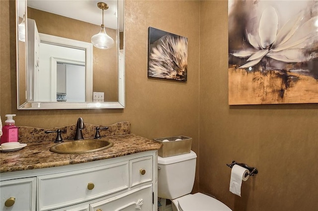 half bathroom with toilet and vanity