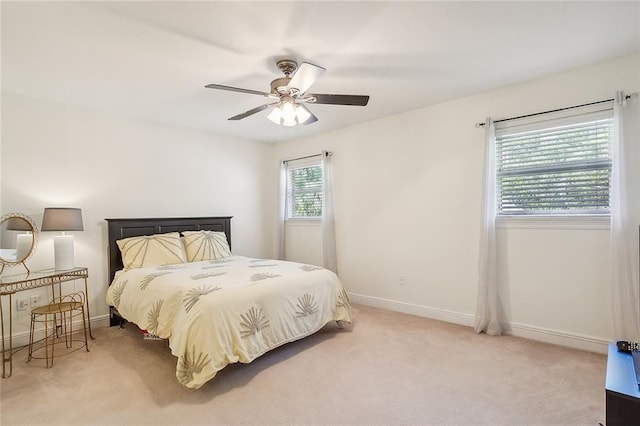 bedroom with ceiling fan and light carpet