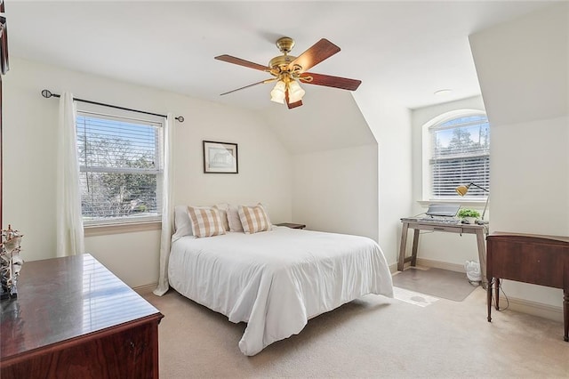 carpeted bedroom featuring ceiling fan and vaulted ceiling