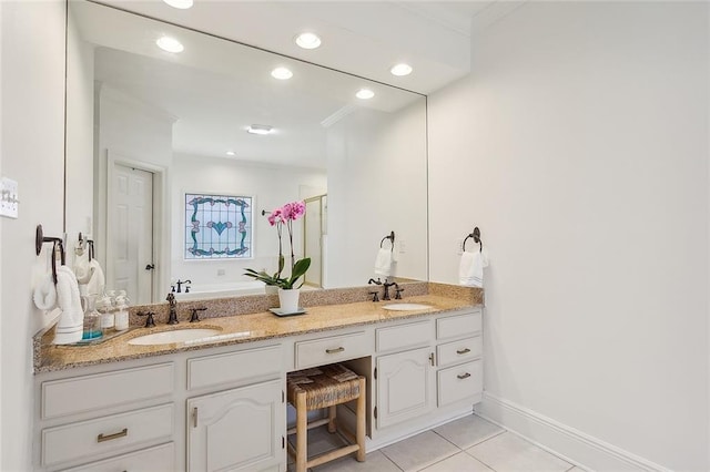 bathroom with crown molding, tile patterned flooring, and vanity