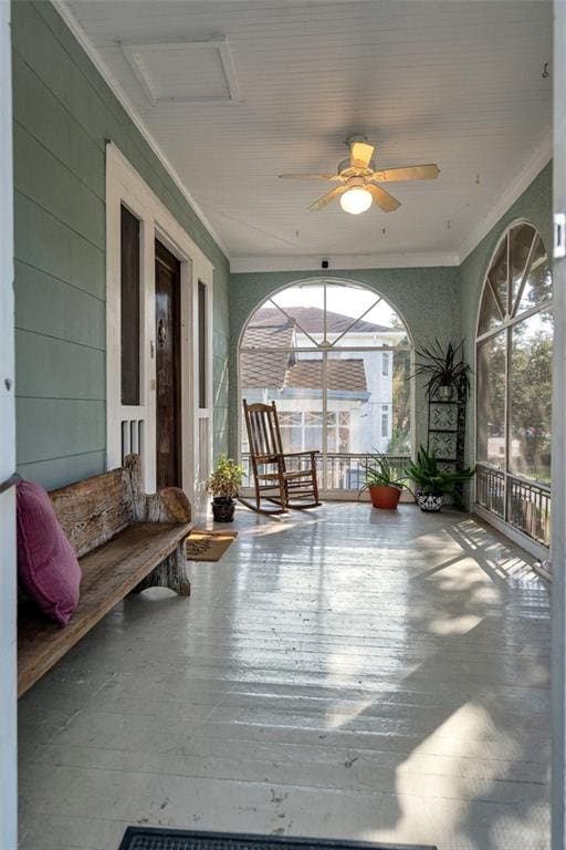 sunroom with ceiling fan and plenty of natural light