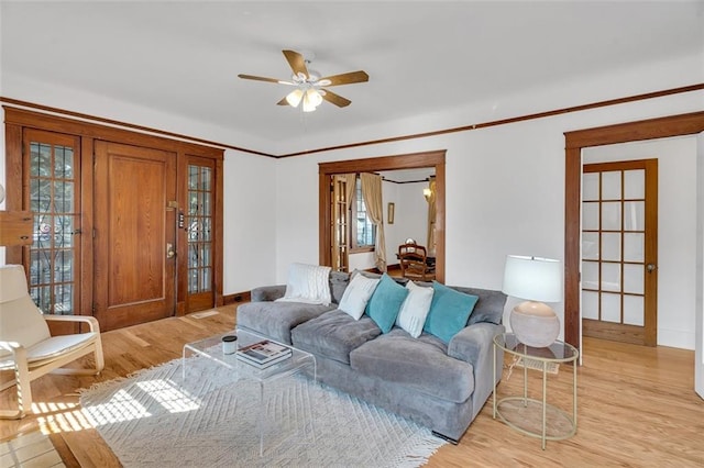 living room featuring ceiling fan and light wood-type flooring