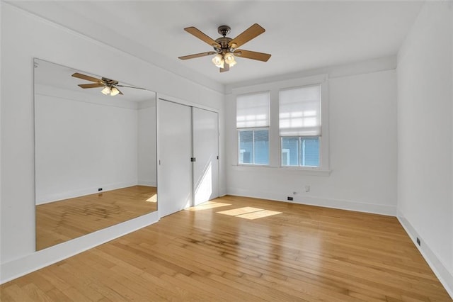 unfurnished bedroom with ceiling fan, a closet, and light hardwood / wood-style floors