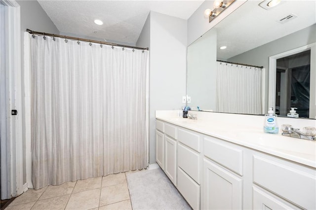 bathroom featuring tile patterned flooring and vanity