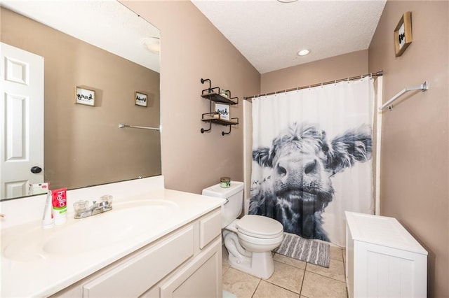 bathroom with vanity, toilet, and tile patterned floors