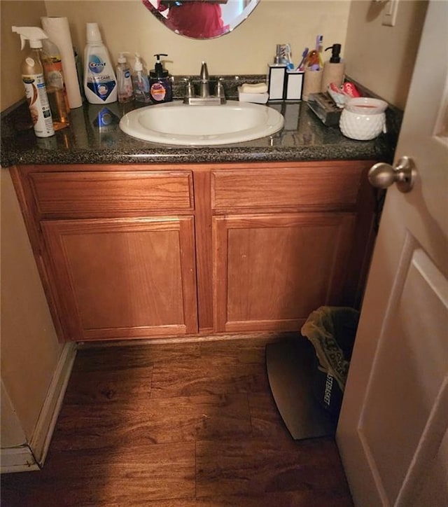 bathroom with hardwood / wood-style floors and vanity