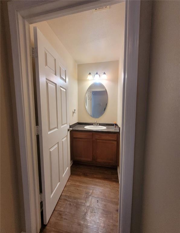 bathroom with vanity and wood-type flooring