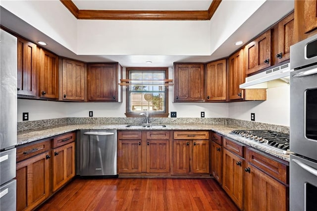 kitchen featuring light stone counters, appliances with stainless steel finishes, dark wood-type flooring, and sink