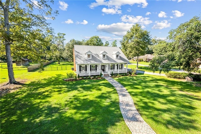 cape cod home featuring a porch and a front lawn