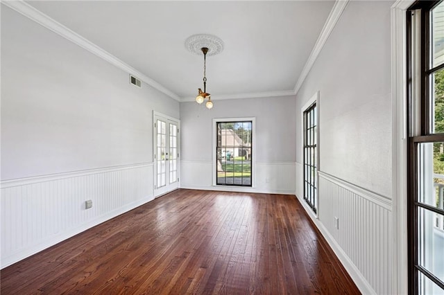 spare room with dark hardwood / wood-style floors and crown molding