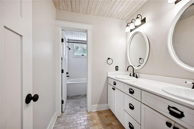 bathroom featuring wooden ceiling, a tub, and vanity