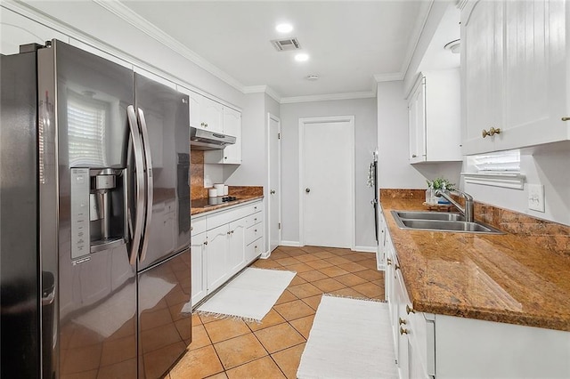 kitchen with under cabinet range hood, a sink, white cabinets, ornamental molding, and stainless steel refrigerator with ice dispenser