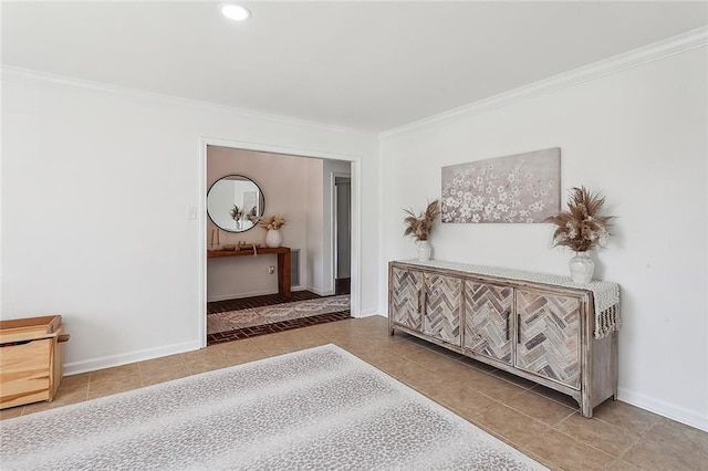 corridor featuring crown molding, baseboards, and tile patterned floors