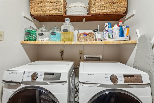 clothes washing area with washer and dryer and laundry area