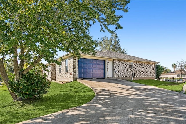 view of front of property featuring a garage and a front lawn