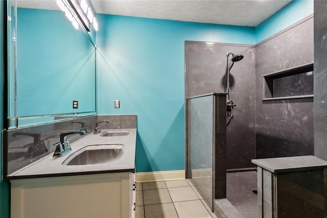 bathroom with vanity, a shower, a textured ceiling, and tile patterned floors