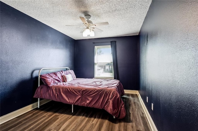 bedroom with wood-type flooring, a textured ceiling, and ceiling fan