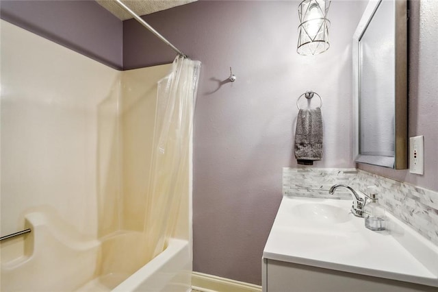 bathroom featuring shower / bath combo with shower curtain and vanity