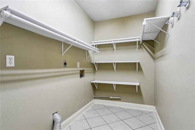 spacious closet with light tile patterned floors