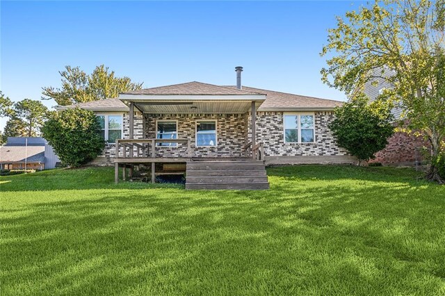 204 Chubasco Ln, Slidell, LA 70458 - back of property featuring a lawn, brick siding, and a wooden deck