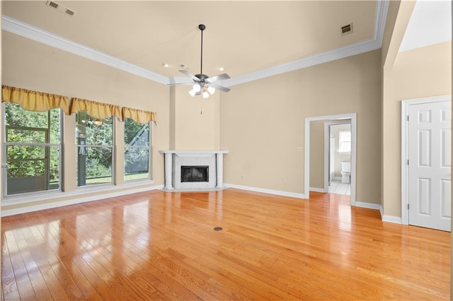 unfurnished living room featuring light hardwood / wood-style floors, ornamental molding, and ceiling fan