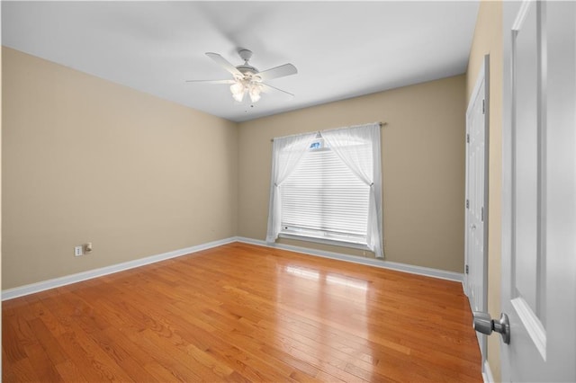 spare room with hardwood / wood-style floors and ceiling fan