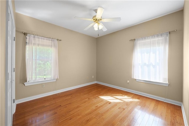 empty room with ceiling fan and hardwood / wood-style floors