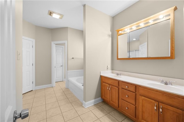 bathroom with a bathtub, tile patterned flooring, and vanity