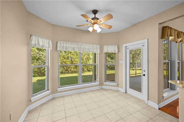 unfurnished sunroom with ceiling fan