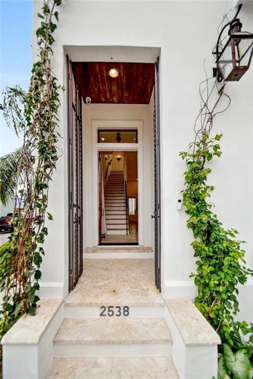 entrance to property featuring stucco siding